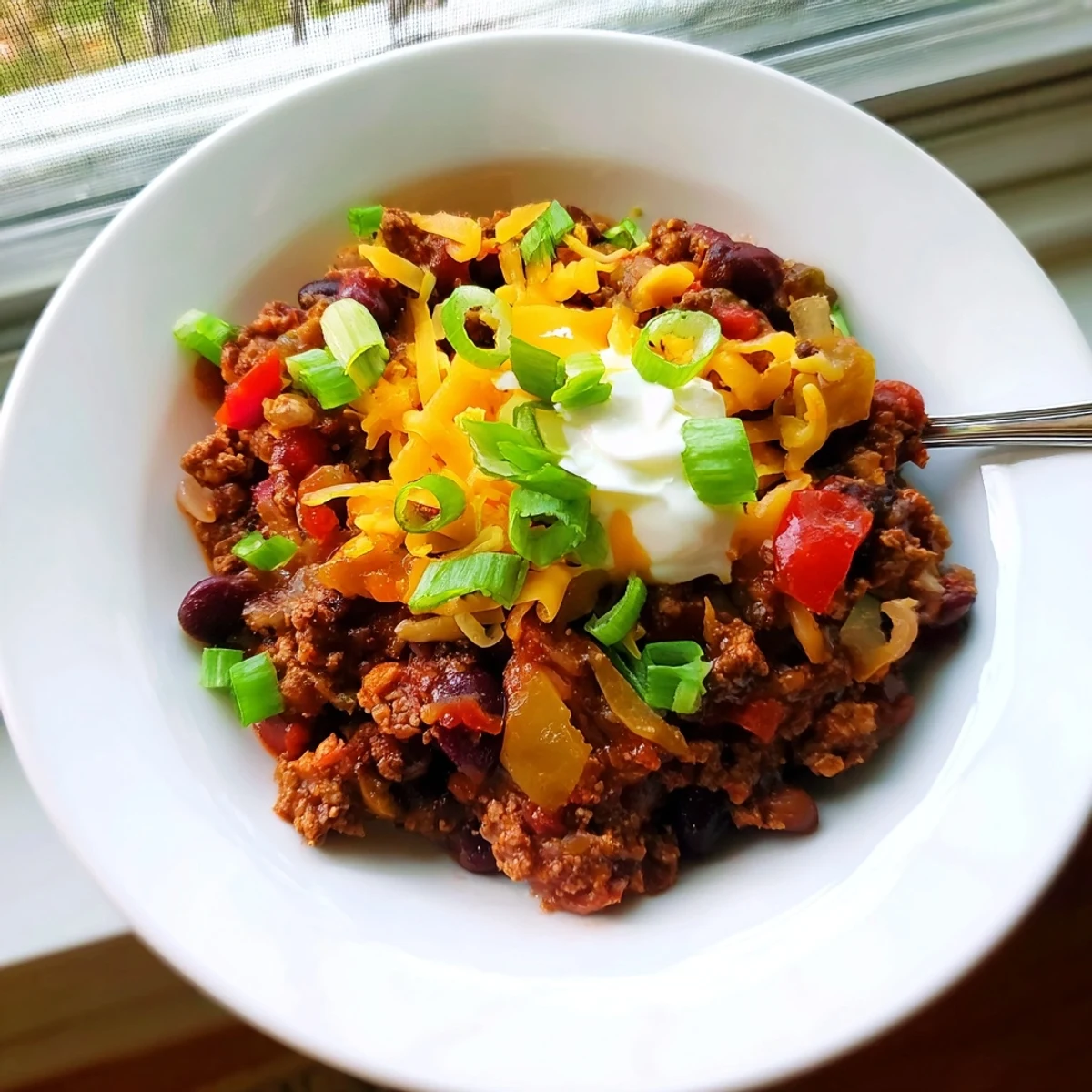 Colorful photo of Simple Weeknight Chili, perfect for a quick, comforting weeknight dinner, garnished.