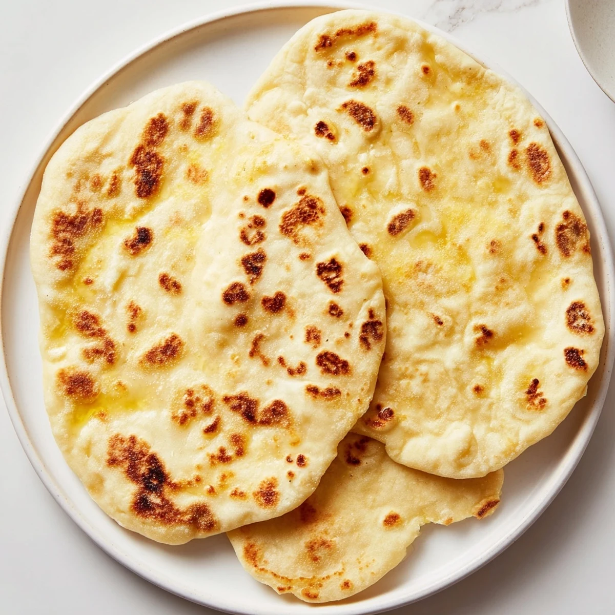 Picture of golden-brown Three-Ingredient Easy Flatbreads, ready to be served with dips.