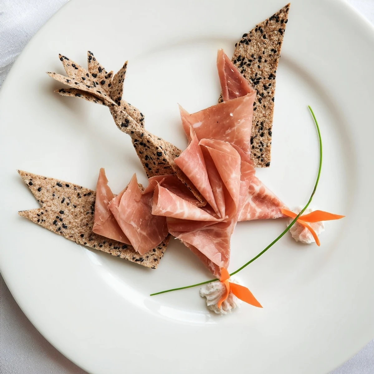 Artfully arranged Paper Crane appetizer, featuring folded cured meats, perfect for elegant gatherings.