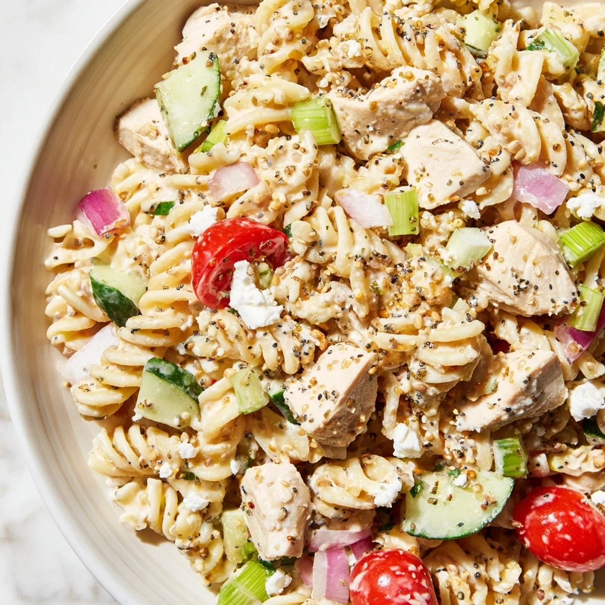 Everything Bagel Chicken Pasta Salad, bursting with fresh veggies and creamy dressing, ready to enjoy.