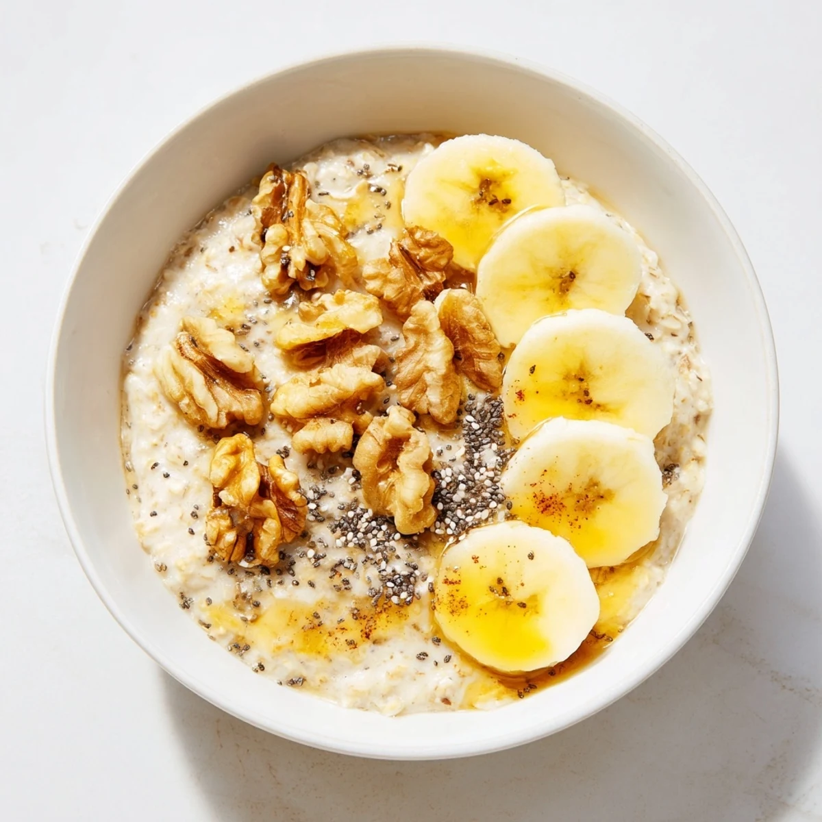 Steaming hot Microwave Banana Oats, garnished with banana slices and nuts, perfect for immediate enjoyment.
