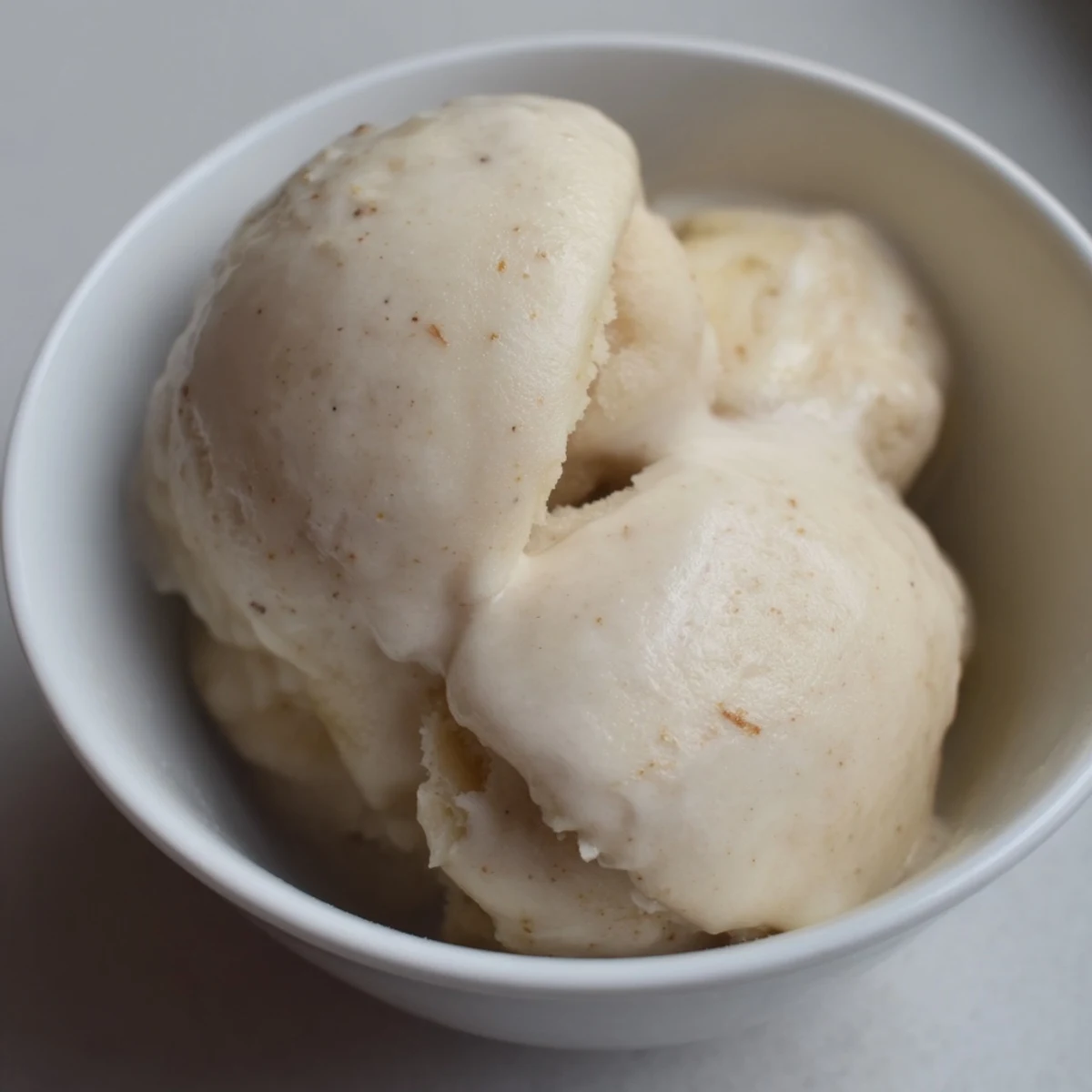 Creamy 2-Ingredient Banana Ice Cream freshly blended, a healthy frozen dessert served in a bowl.