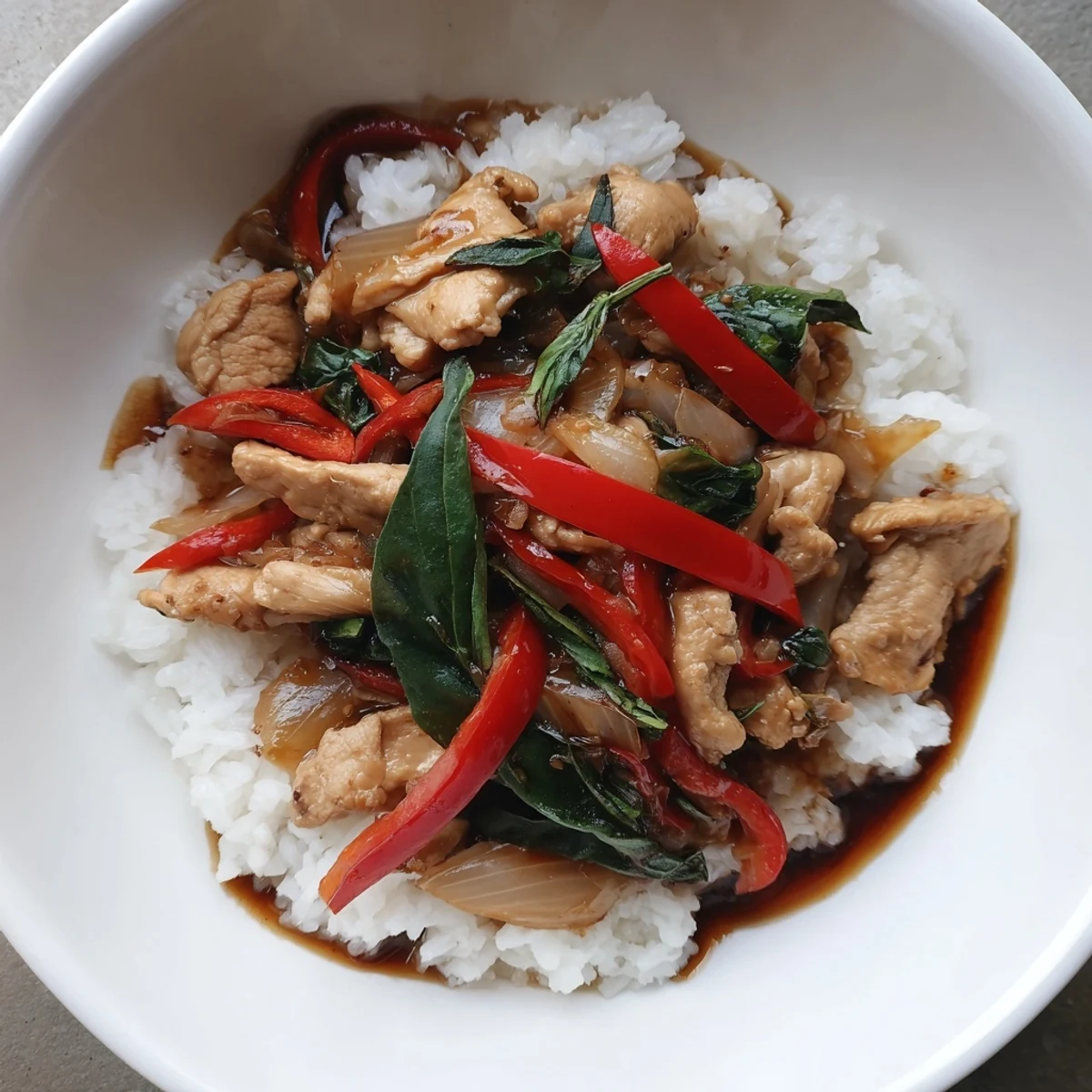 Steaming Thai Basil Chicken Bowls, a delicious blend of basil and savory chicken atop fluffy rice.