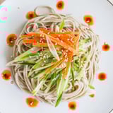 A close-up view of perfectly layered Chilled Noodle Lunch Cups, a refreshing vegetarian meal.