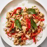 A close-up of flavorful Thai Basil Chicken Bowls, perfect for a quick and easy weeknight meal idea.
