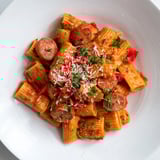 A flavorful plate of Spanish Chorizo Pasta showcases perfectly cooked penne with rich chorizo and vegetables.