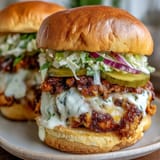 Crispy-edged smash burger sliders piled high with cheese, pickles, and secret sauce.