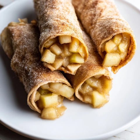 Golden-brown Apple Pie Roll-Ups: Crispy tortillas filled with spiced apples, ready to enjoy.