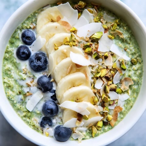 Creamy Matcha Overnight Oats boast fresh berries and a hint of sweetness, ready to enjoy.