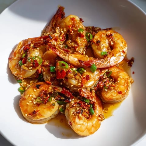 Golden, glistening Korean Garlic Butter Shrimp, ready to serve with fresh green scallions and sesame seeds.