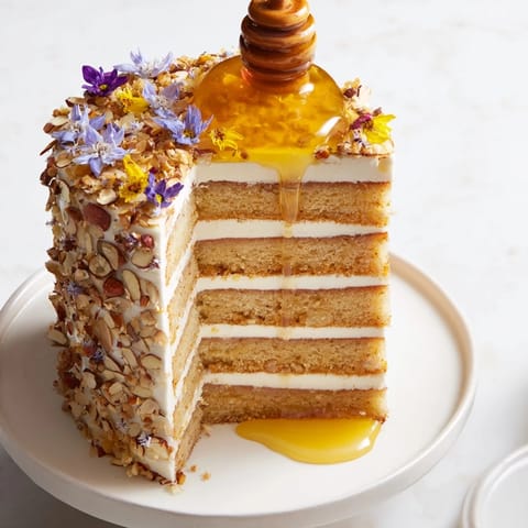 A decadent slice of The Honey-Drip, showcasing the rich honey cake and flowing honey center.