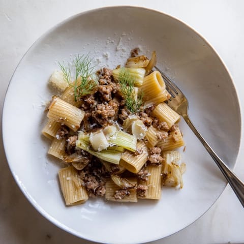Sizzling Italian sausage and thinly sliced fennel sizzle in a skillet, ready to toss with penne and a light aromatic sauce for this cozy winter pasta.