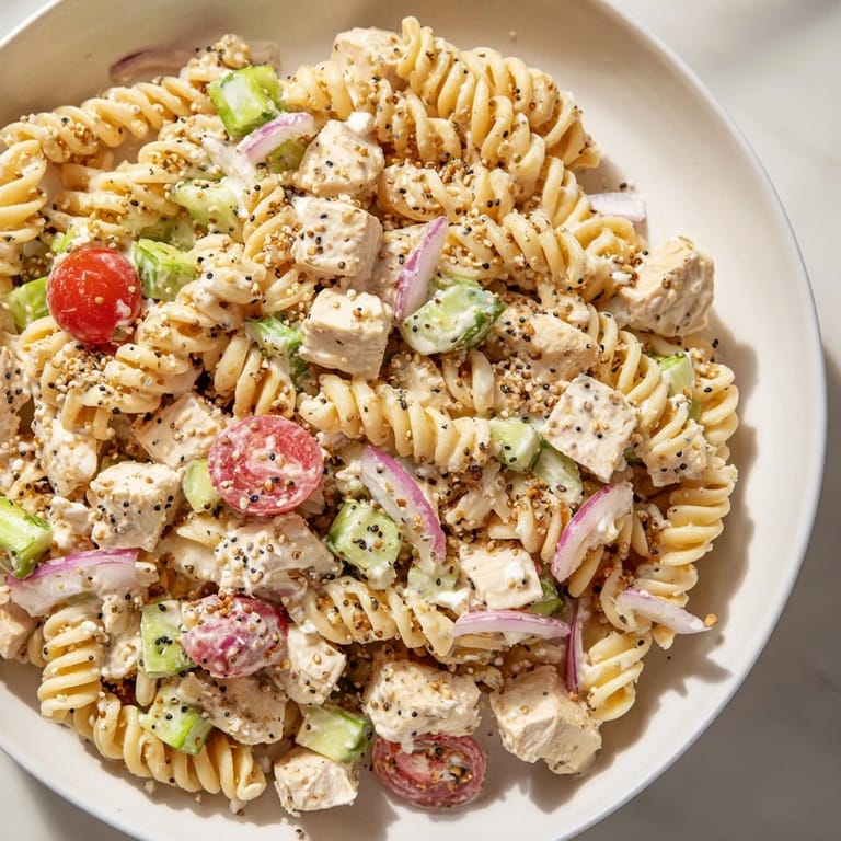 Flavorful everything bagel seasoning coats every bite of this chilled Chicken Pasta Salad, perfect for gatherings.