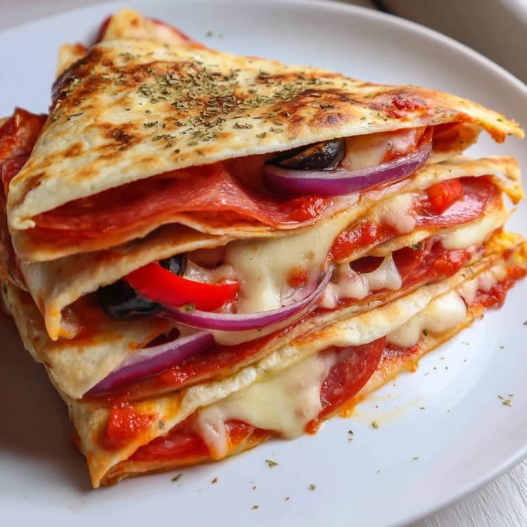 Serving suggestion of a Tortilla Pizza Wrap cut in half, paired with a side salad and marinara dipping sauce.