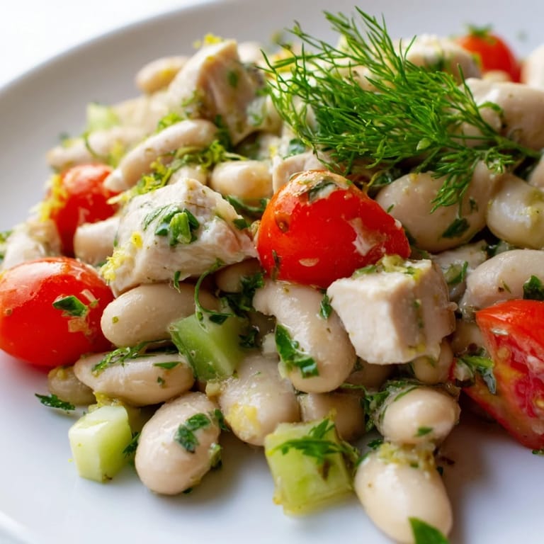 Bright Mediterranean flavors shine in this protein-packed Lemony White Bean Chicken Salad, served chilled or at room temperature on a bed of greens.
